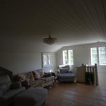 living room with a healthy amount of sunlight, hardwood floors, and vaulted ceiling